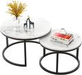 Two-piece nesting round table with a marble top and black metal frame